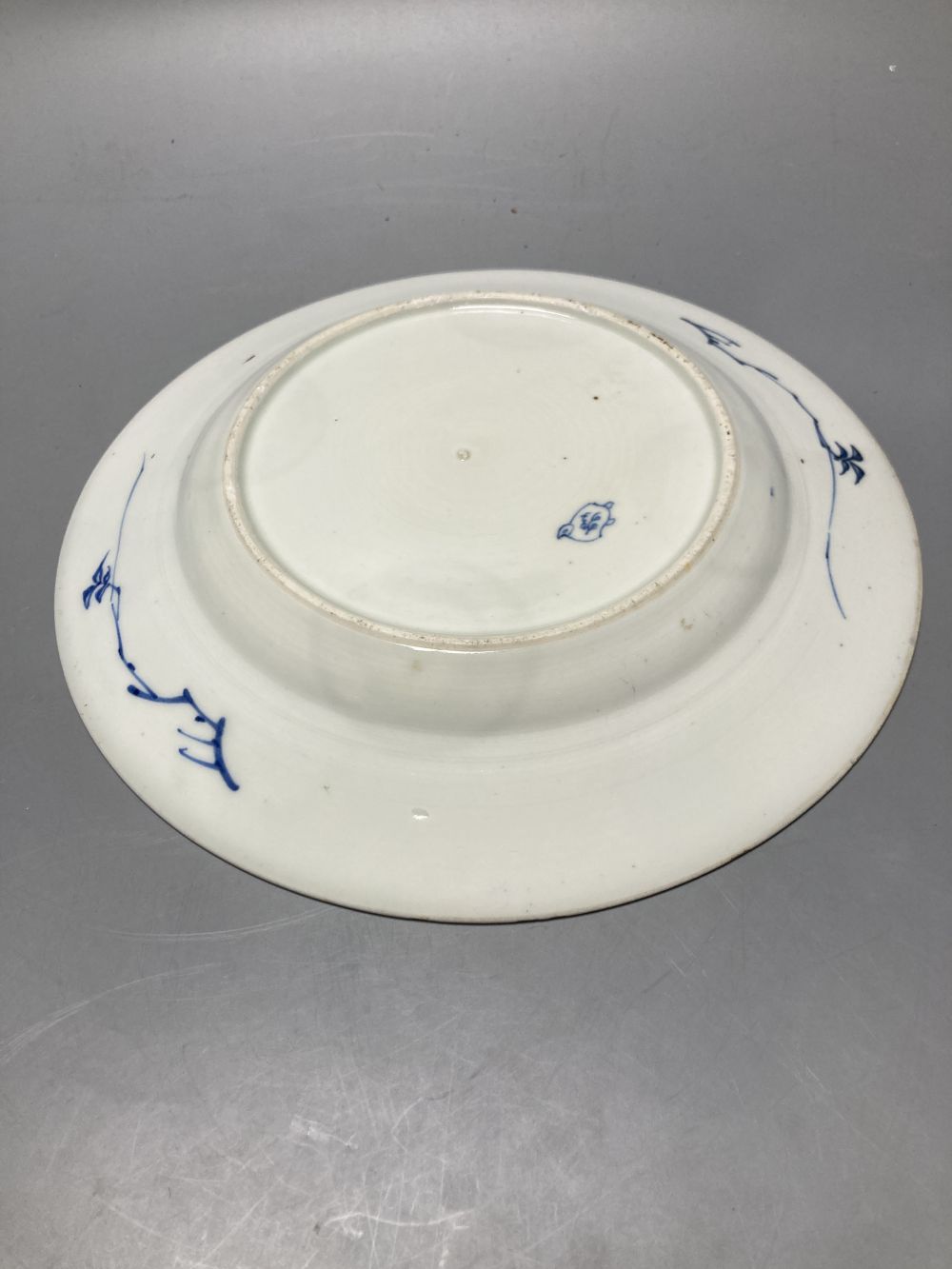 An 18th century Chinese famille rose plate together with a Chinese blue and white plate and a famille rose mug lacking handle, largest